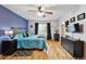 Comfortable bedroom with hardwood floors, a bed with gray headboard, and window views at 4819 Jericho Ct, Denver, CO 80249