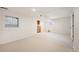 Finished basement with neutral paint, neutral carpet, and two bright windows at 4605 S Yosemite St # 36, Denver, CO 80237