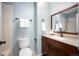 Updated bathroom with granite counters, bronze fixtures, framed mirror, and tiled shower at 4605 S Yosemite St # 36, Denver, CO 80237