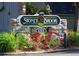 Stoney Brook community sign with well-maintained landscaping and colorful flowers at 4605 S Yosemite St # 36, Denver, CO 80237