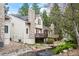 Charming home exterior with stone accents, a pond, and mature trees at 4605 S Yosemite St # 36, Denver, CO 80237