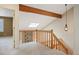 Landing with skylight, wooden beam, wooden bannister, and pendant lighting at 4605 S Yosemite St # 36, Denver, CO 80237