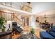 Spacious living room featuring a staircase, hardwood floors, a dining area, and access to the front door at 4605 S Yosemite St # 36, Denver, CO 80237