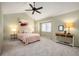 Bright main bedroom boasts vaulted ceiling with fan, plush carpet, and warm paint at 4605 S Yosemite St # 36, Denver, CO 80237