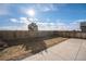 Large backyard featuring a privacy fence, tree, grass and concrete patio at 47356 Lilac Ave, Bennett, CO 80102