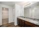 Bathroom offers double sinks with granite countertop and large vanity mirror at 47356 Lilac Ave, Bennett, CO 80102