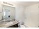 Bathroom features a granite countertop, ceramic tile tub surround, and modern fixtures at 47356 Lilac Ave, Bennett, CO 80102