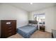 Cozy bedroom features plush carpeting, natural light, and neutral decor at 47356 Lilac Ave, Bennett, CO 80102