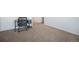 Bedroom with neutral carpet and trim features a desk and modern furnishings at 47356 Lilac Ave, Bennett, CO 80102