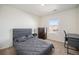 Bedroom features neutral decor, carpet, a large window, desk, and built-in drawers at 47356 Lilac Ave, Bennett, CO 80102