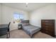 This bright bedroom features neutral decor, a built in wardrobe, and a large window at 47356 Lilac Ave, Bennett, CO 80102