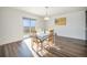 Bright dining area with wood flooring, views of the back yard and natural light at 47356 Lilac Ave, Bennett, CO 80102