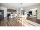 Open concept dining area featuring wood flooring, views of the kitchen and living room and natural light at 47356 Lilac Ave, Bennett, CO 80102
