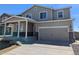 Charming two-story home with a covered porch, attached garage, and well-maintained lawn in a desirable neighborhood at 47356 Lilac Ave, Bennett, CO 80102