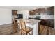 Well-equipped kitchen with granite countertops, dark wood cabinets, stainless steel appliances and stylish backsplash at 47356 Lilac Ave, Bennett, CO 80102