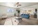Inviting living room with large window, neutral carpet and an open floorplan with views of the kitchen and dining area at 47356 Lilac Ave, Bennett, CO 80102
