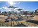 Community playground with slides, climbing structures, picnic pavilion, benches, and lush landscaping at 47356 Lilac Ave, Bennett, CO 80102