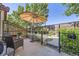 Relaxing backyard patio area with umbrella, chairs, and lush landscaping at 4555 S Auckland Ct, Aurora, CO 80015