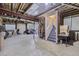 Unfinished basement featuring concrete floors, exposed utilities, and stairs to upper level at 4555 S Auckland Ct, Aurora, CO 80015