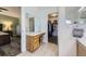 Bathroom with a vanity area, a stool, and a walk-in closet with plenty of storage and organization options at 4555 S Auckland Ct, Aurora, CO 80015