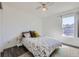 Bright bedroom with a cozy bed, a side table, and a large window that fills the space with natural light at 4555 S Auckland Ct, Aurora, CO 80015