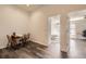 The dining area is adjacent to bedrooms with wood floors and a bright ambiance at 4555 S Auckland Ct, Aurora, CO 80015