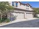 Two-story townhome featuring attached garages with well-maintained landscaping at 4555 S Auckland Ct, Aurora, CO 80015