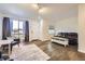 Open-concept living room featuring hardwood floors, neutral walls, and large windows at 4555 S Auckland Ct, Aurora, CO 80015