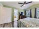 The main bedroom features wood floors, vaulted ceilings, a ceiling fan, and an attached bathroom and walk-in closet at 4555 S Auckland Ct, Aurora, CO 80015