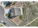 Aerial view of a well-maintained property featuring a spacious driveway, lush lawn, and fenced yard in a serene location at 5641 Echo Hollow St, Castle Rock, CO 80104