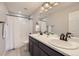 Bathroom features a double vanity, tub with shower, and modern fixtures at 5641 Echo Hollow St, Castle Rock, CO 80104