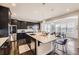 Modern kitchen with large center island, stainless steel appliances, and dark wood cabinets at 5641 Echo Hollow St, Castle Rock, CO 80104