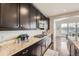 Modern kitchen with granite countertops, stainless steel appliances, and dark wood cabinets at 5641 Echo Hollow St, Castle Rock, CO 80104