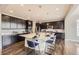 Modern kitchen with large center island, stainless steel appliances, and dark wood cabinets at 5641 Echo Hollow St, Castle Rock, CO 80104