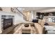 Cozy living room with a stone fireplace, hardwood floors, and stylish furniture at 5641 Echo Hollow St, Castle Rock, CO 80104