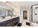 Elegant main bathroom with double vanity, granite countertops, and tiled shower at 5641 Echo Hollow St, Castle Rock, CO 80104