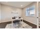 Bright office space features a white desk, blue chair, neutral walls, and a window at 5641 Echo Hollow St, Castle Rock, CO 80104