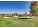 Vibrant community playground with play structures, picnic tables, and a grassy field, perfect for Gathering fun and recreation at 5641 Echo Hollow St, Castle Rock, CO 80104