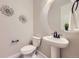 Stylish powder room showcasing a pedestal sink, sunflower decor, and modern fixtures at 5641 Echo Hollow St, Castle Rock, CO 80104