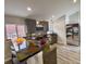 Modern kitchen with stainless steel appliances, unique countertops, breakfast bar, and gray cabinets at 26259 Kingsbury Rd, Kittredge, CO 80457