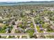 Beautiful aerial shot shows homes, mature trees, and open space in the neighborhood at 6116 W Frost Dr, Littleton, CO 80128