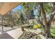 Backyard features a deck, pond, mature trees, and landscaping at 6116 W Frost Dr, Littleton, CO 80128