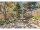 Backyard patio featuring a decorative fountain, stone bench, and lush landscaping at 6116 W Frost Dr, Littleton, CO 80128