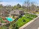 Aerial view showing a backyard oasis complete with swimming pool, mature trees, and green grass at 6116 W Frost Dr, Littleton, CO 80128
