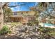 Exterior view of the backyard with a fountain, pool, patio, and landscaping at 6116 W Frost Dr, Littleton, CO 80128