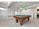 Basement space with a pool table and built-in white shelving for storage and display at 6116 W Frost Dr, Littleton, CO 80128