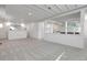 Carpeted basement showcasing a dry bar, shelving, and white walls at 6116 W Frost Dr, Littleton, CO 80128