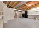Unfinished basement with exposed beams and shelving offers plenty of storage space at 6116 W Frost Dr, Littleton, CO 80128