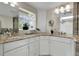 Bathroom featuring double sinks, granite countertops, and ample cabinet space for storage at 6116 W Frost Dr, Littleton, CO 80128