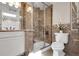 Beautiful bathroom featuring a glass enclosed shower, neutral tile, and a white commode at 6116 W Frost Dr, Littleton, CO 80128